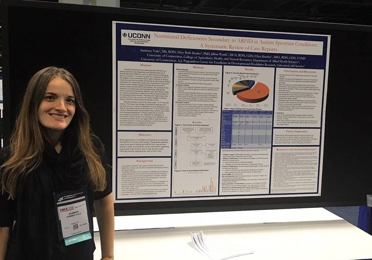 About page: Photo of Summer Yule, MS, RDN with her poster on nutrient deficiencies secondary to avoidant-restrictive food intake disorder in autism