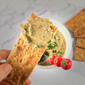 Smoked Oyster and Cod Liver Pate on a cracker, with additional pate in a ramekin in the background