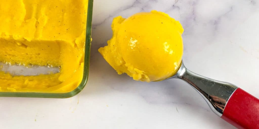 Mango nice cream in an ice cream scoop